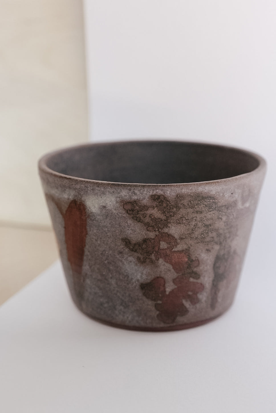 Ceramic cup with a textured surface on a white background