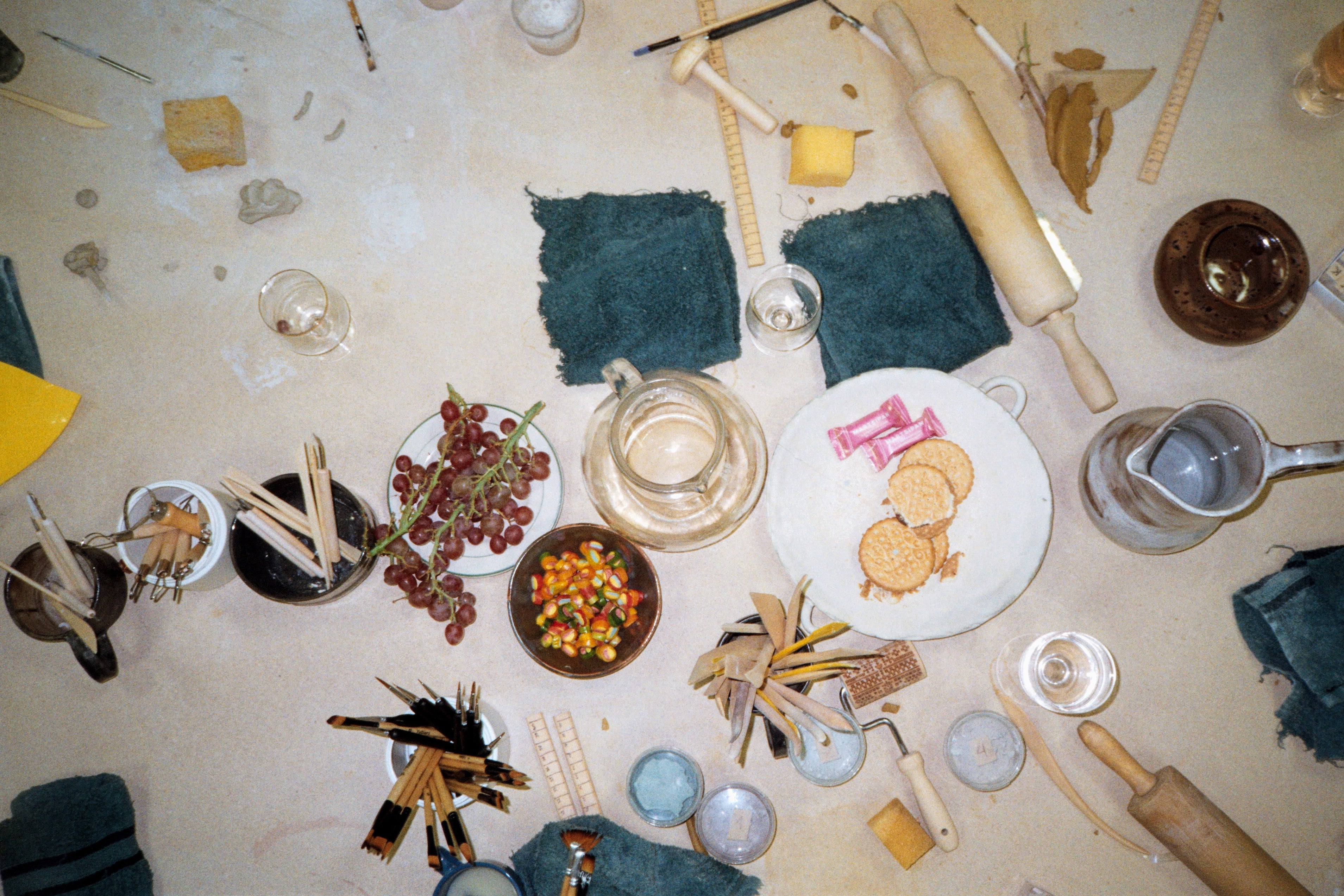 Top-down view of a table with various items including food, utensils, and decorative elements.